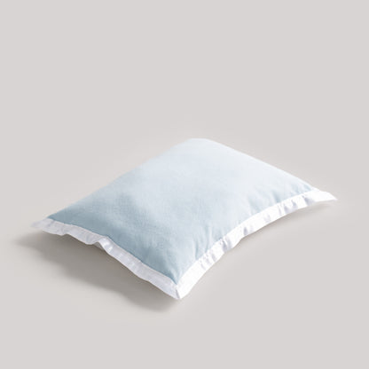 Light blue pillow on a beige background
