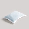Light blue pillow on a beige background