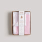 Pink security blanket in a cardboard box with a label on a light gray background