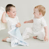 baby and toddler playing with baby security blankets, pink and white